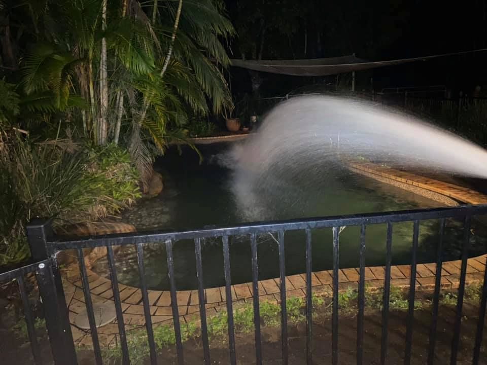 A Fence Surrounds a Swimming Pool at Night — Jaiden Tanners Water Supplies in Tyalgum, NSW