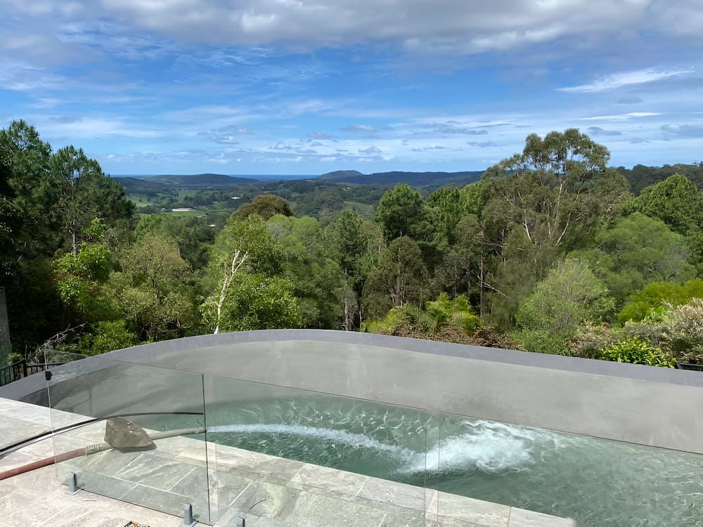 A Large Swimming Pool With a View of a Forest and Mountains — Jaiden Tanners Water Supplies in Murwillumbah, NSW