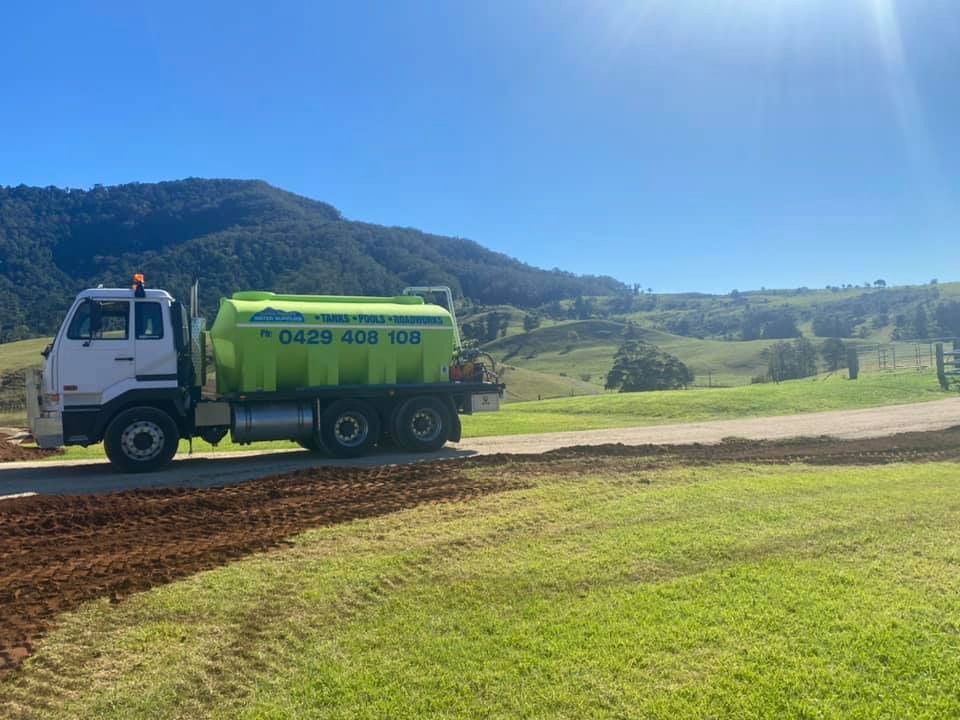 A Green and White Truck is Parked on the Side of a Dirt Road — Jaiden Tanners Water Supplies in Mullumbimby, NSW