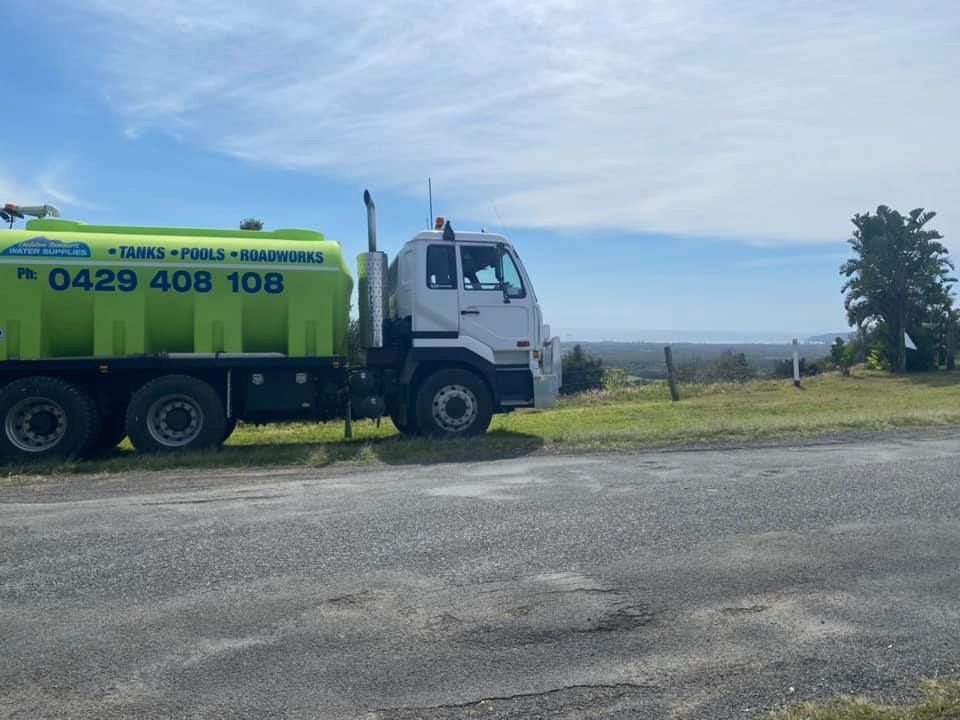 A green and white truck is parked on the side of the road — Jaiden Tanners Water Supplies in Murwillumbah, NSW