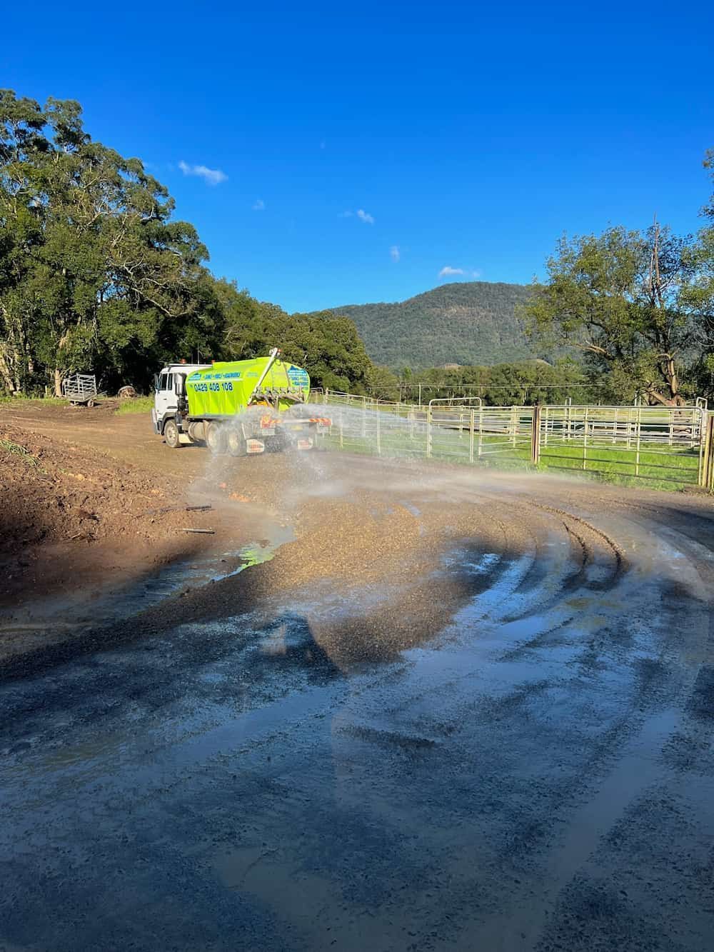 A Green and White Truck is Driving Down a Dirt Road — Jaiden Tanners Water Supplies in Murwillumbah, NSW