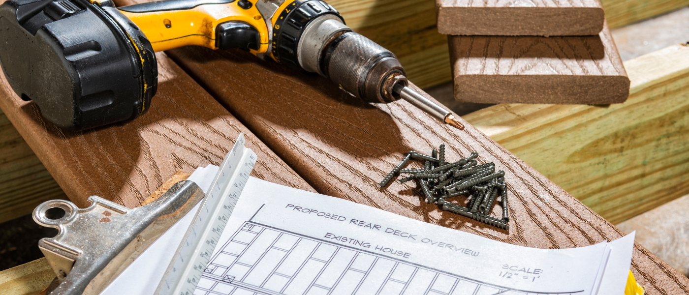 A photo of deck tools sitting on top of composite deck boards.