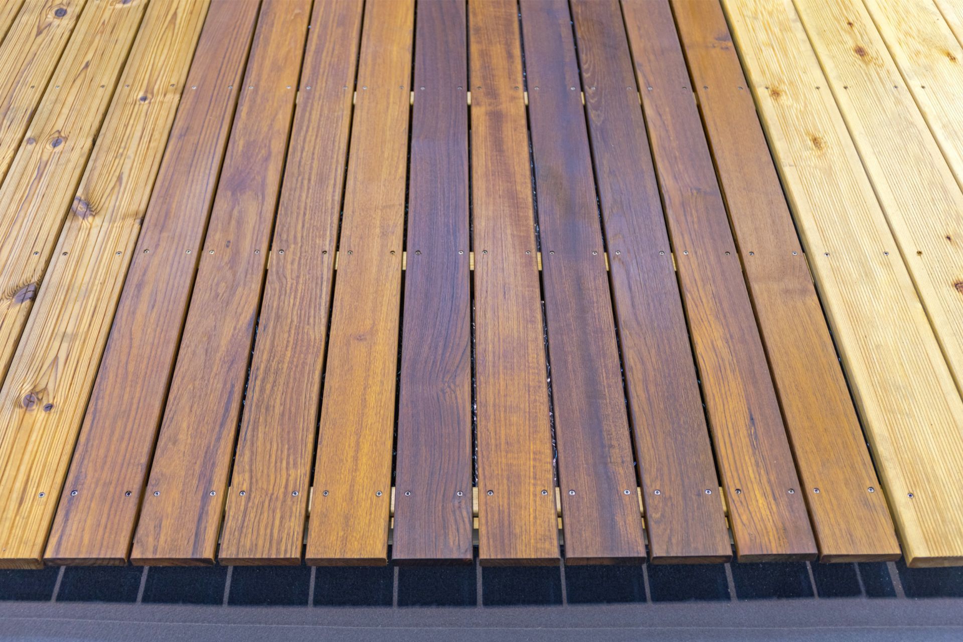 A photo of various wooden deck boards in Athens, GA. THe deck boards are local wood types that can be found in Athens, GA