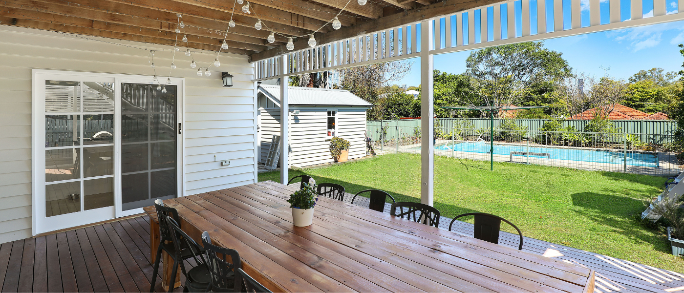 A photo of a deck and patio in a small backyard. Despite the small yard, the deck design still looks great because the space is optimized correctly.
