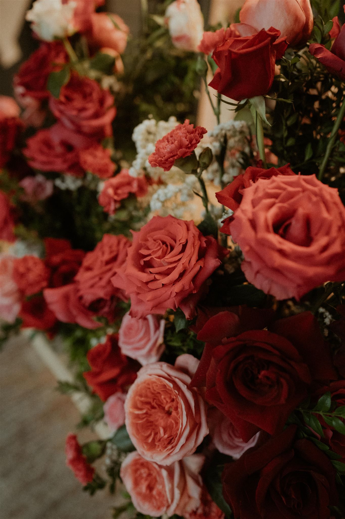 Arrangement of red, pink, and white roses, close-up with a soft focus.