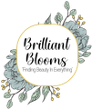 Brilliant Blooms logo with black script on a gold-outlined white oval, floral accents on either side.