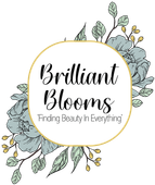 Brilliant Blooms logo with black script on a gold-outlined white oval, floral accents on either side.