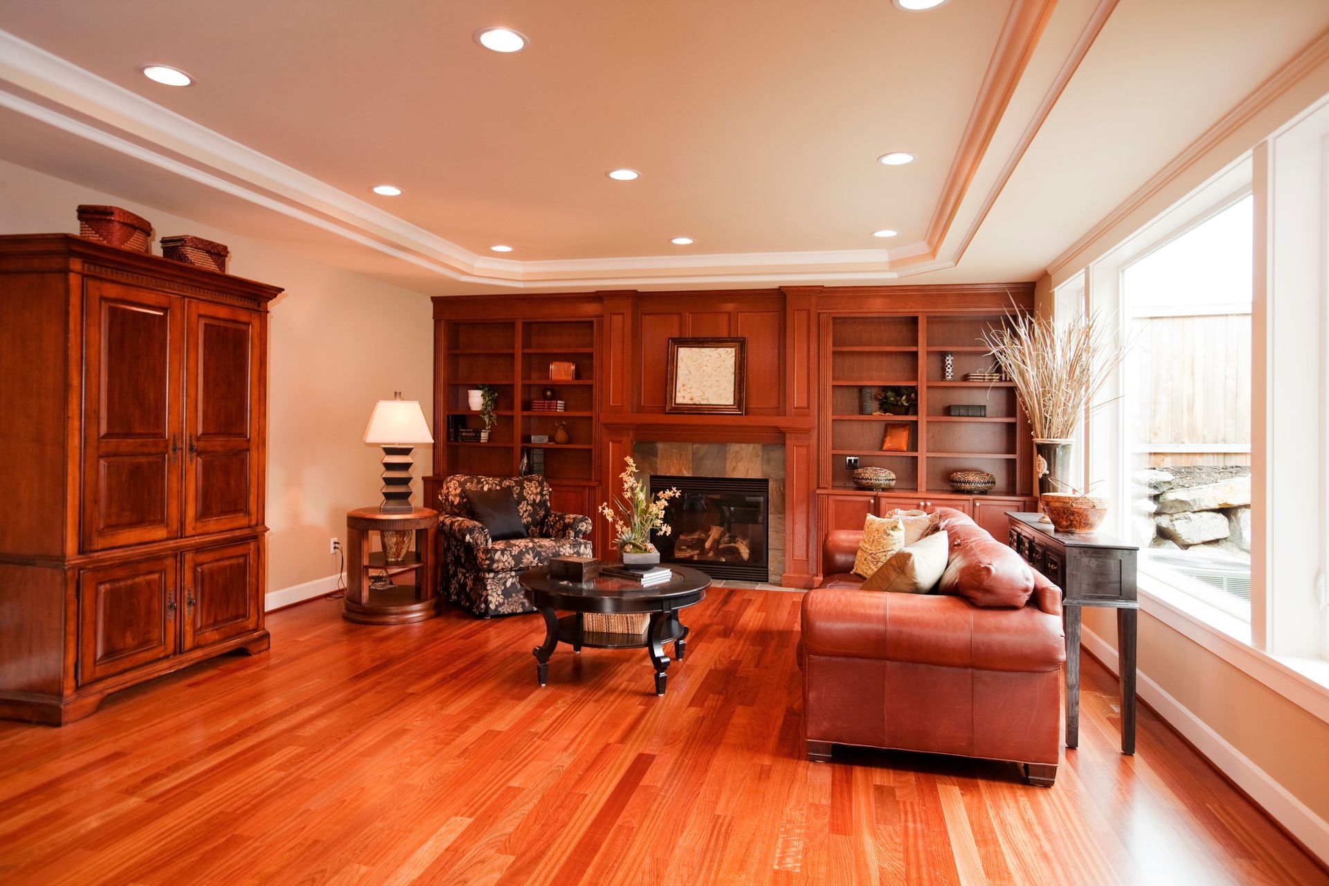 A living room with hardwood floors and a fireplace.
