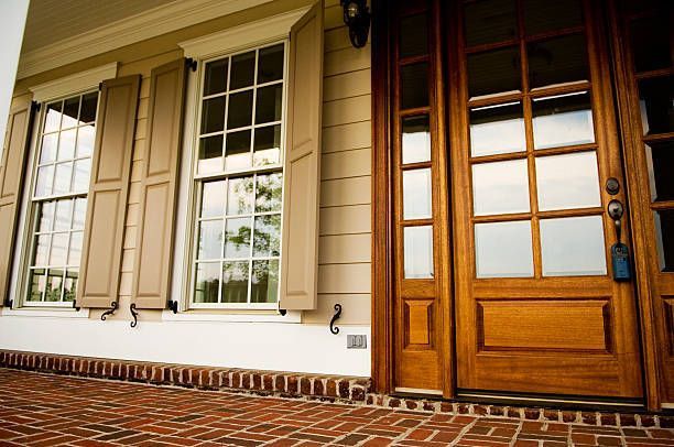 A house with a wooden door and shutters on the windows