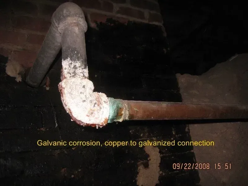 A picture of a galvanic corrosion copper to galvanized connection