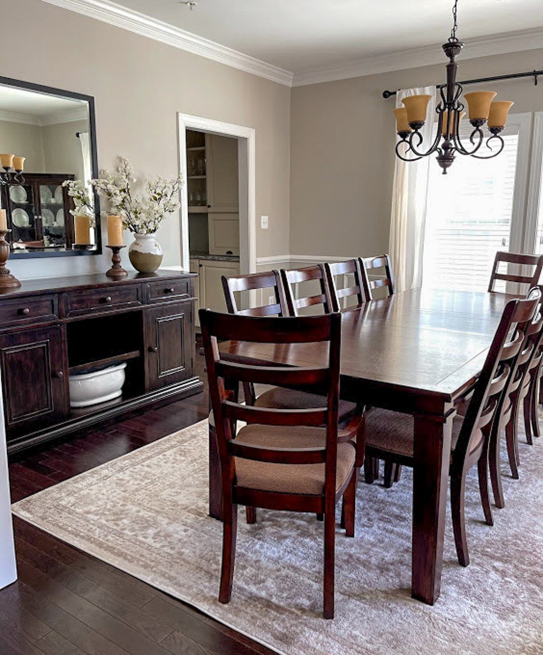 A dining room with a long table and chairs