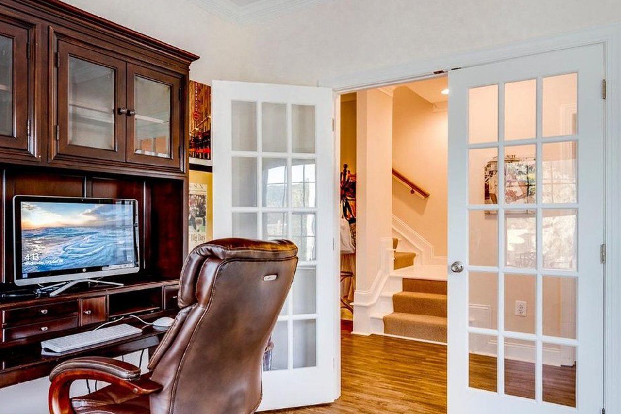 A chair is sitting in front of a desk with a computer on it.