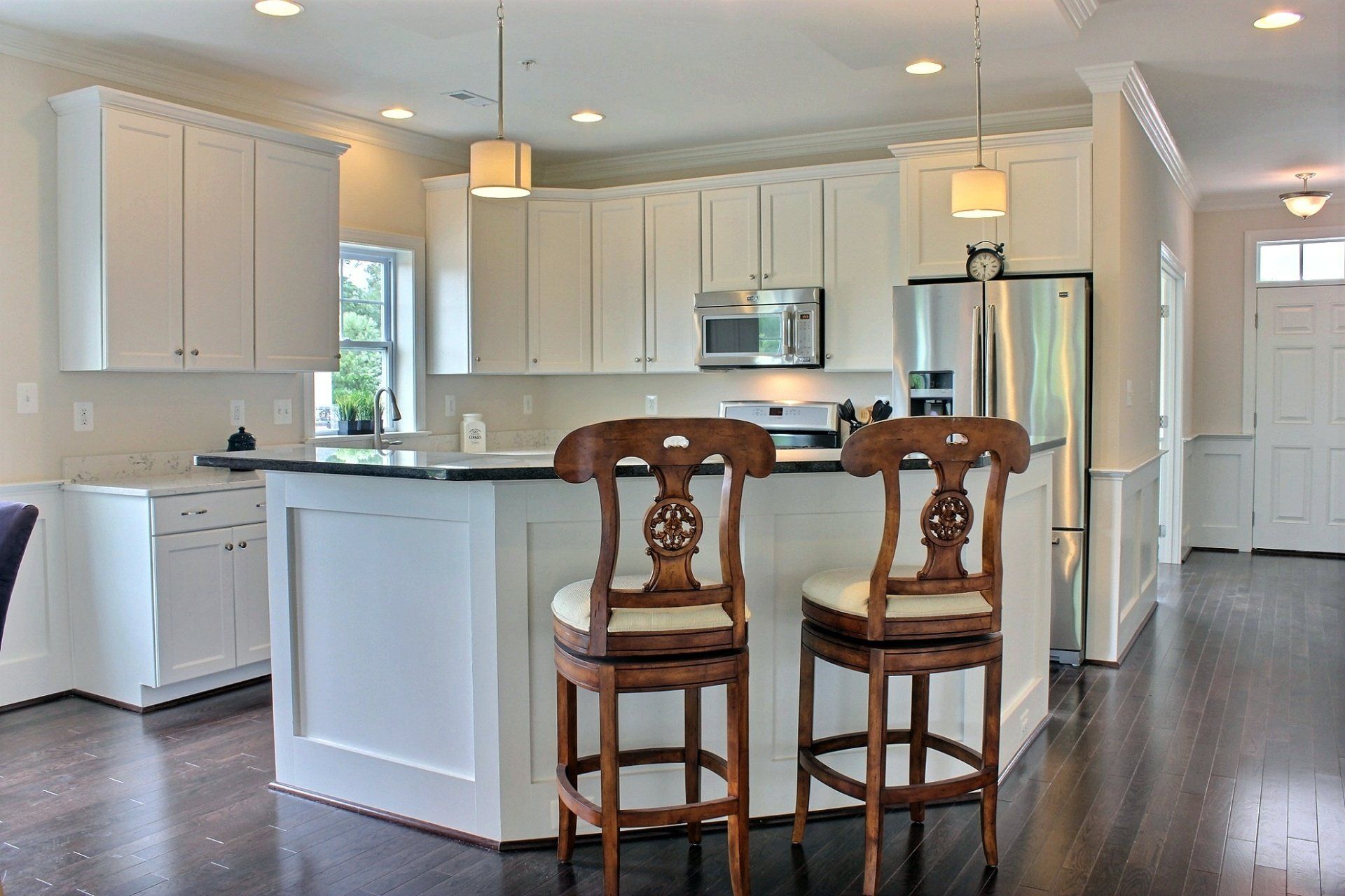 Modern kitchen from side angle in home with two brown chairs | Build on Your Lot | Covell Communities | Chester, Maryland 21619