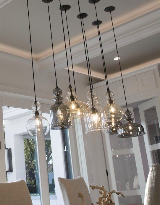 A dining room with a lot of lights hanging from the ceiling