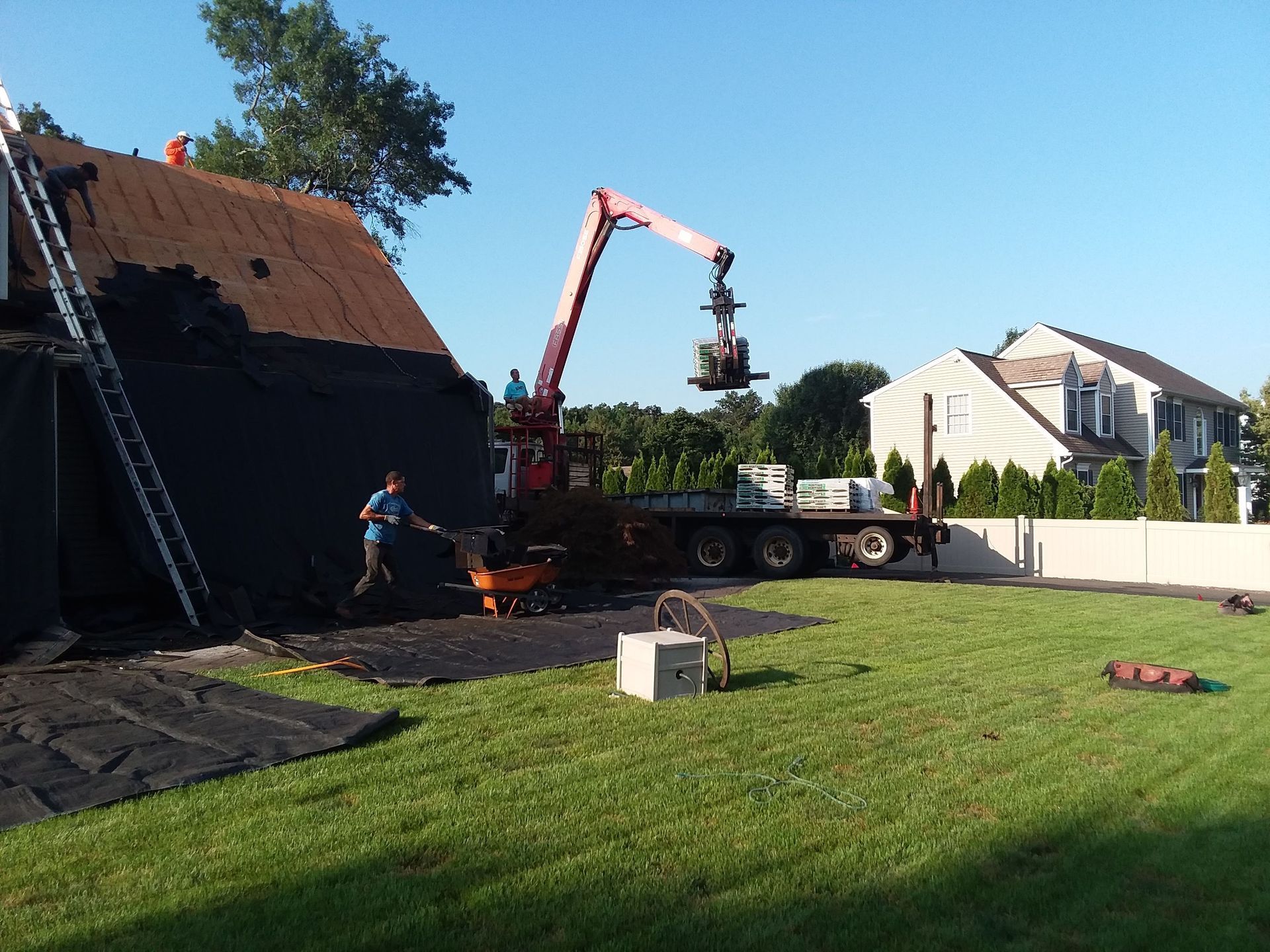A man is working on a roof with a crane