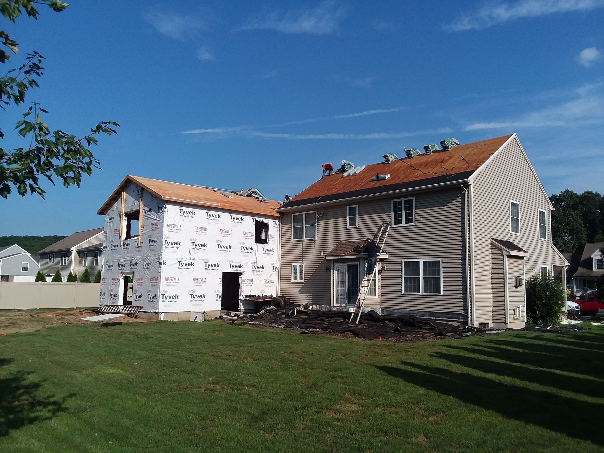 A house under construction with a red roof