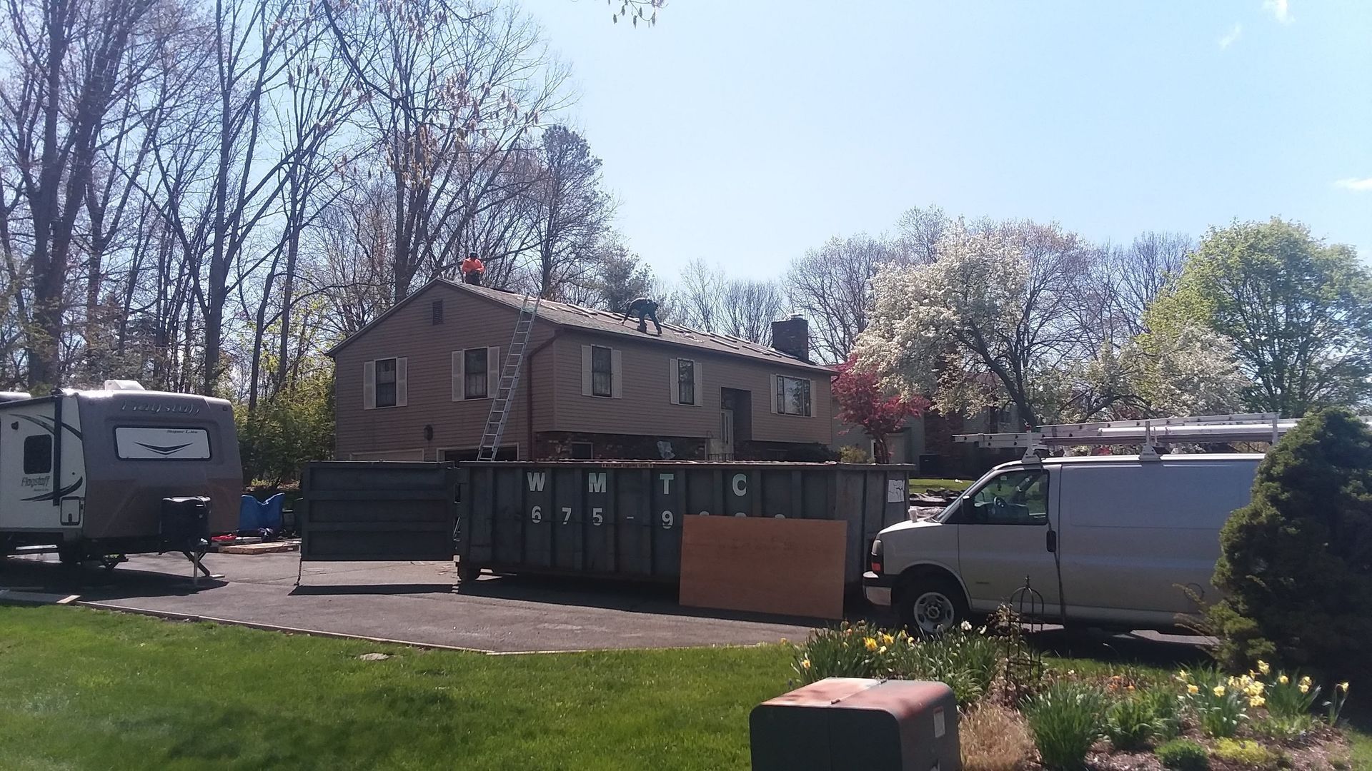 A white van is parked in front of a house