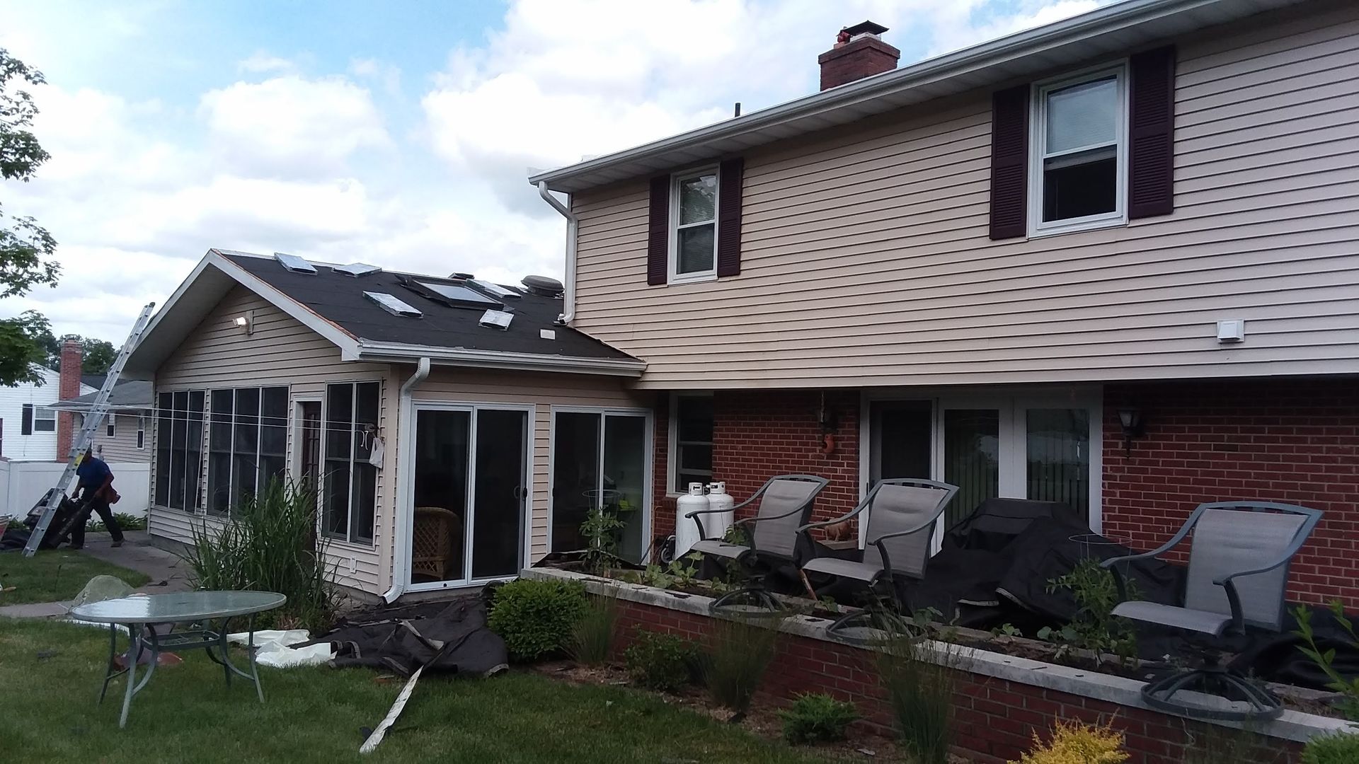 A house with a table and chairs in front of it