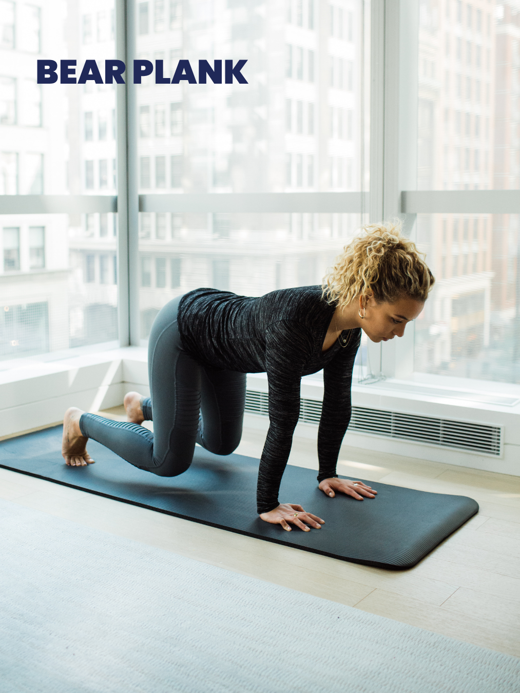 A woman is doing a bear plank on a yoga mat.