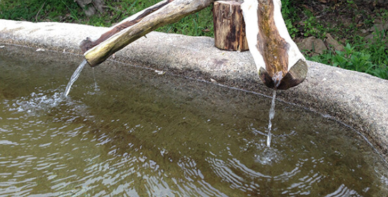 A close up of a fountain with water coming out of it.