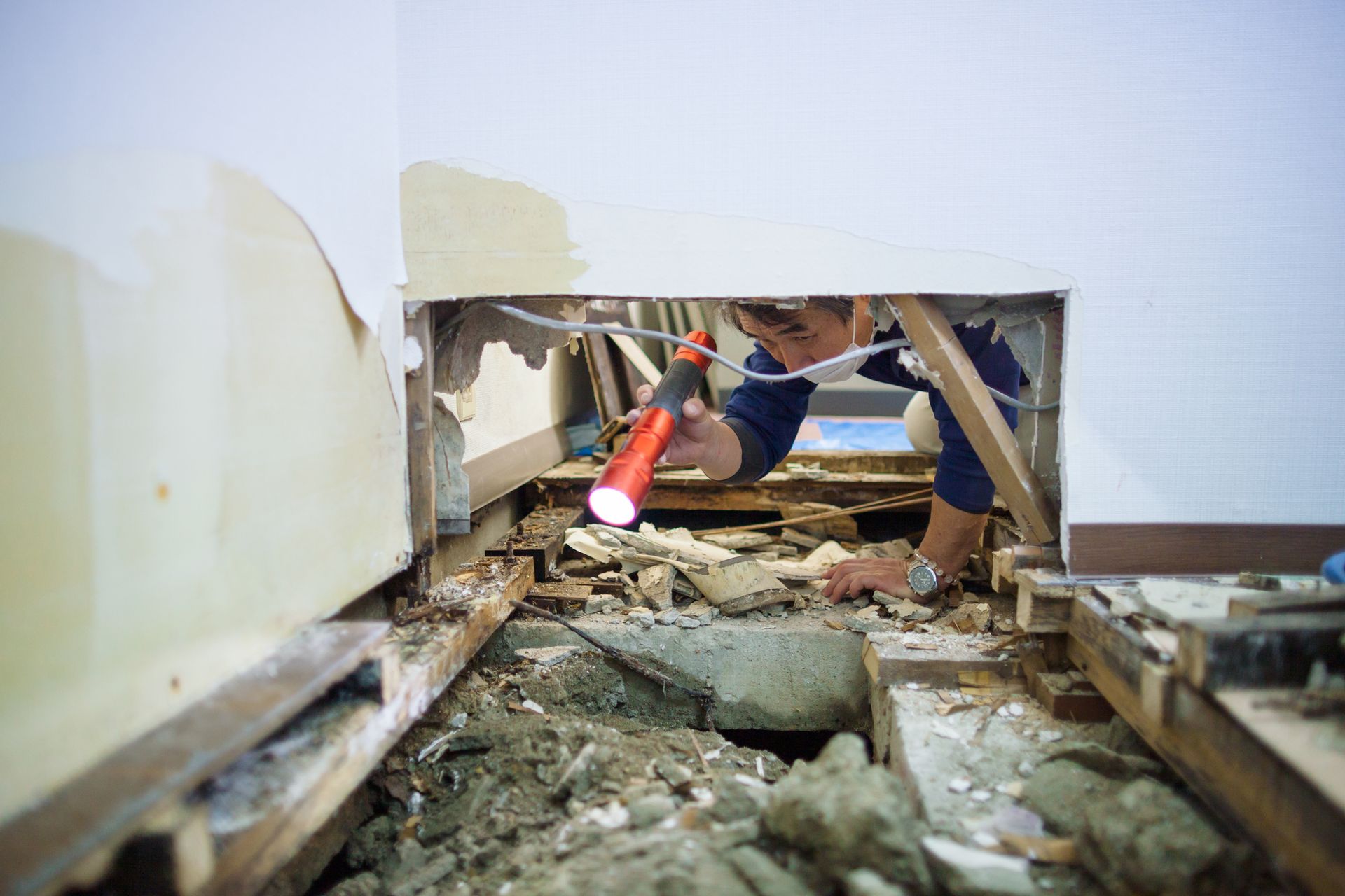 Blue air movers in a kitchen; likely drying after water damage.