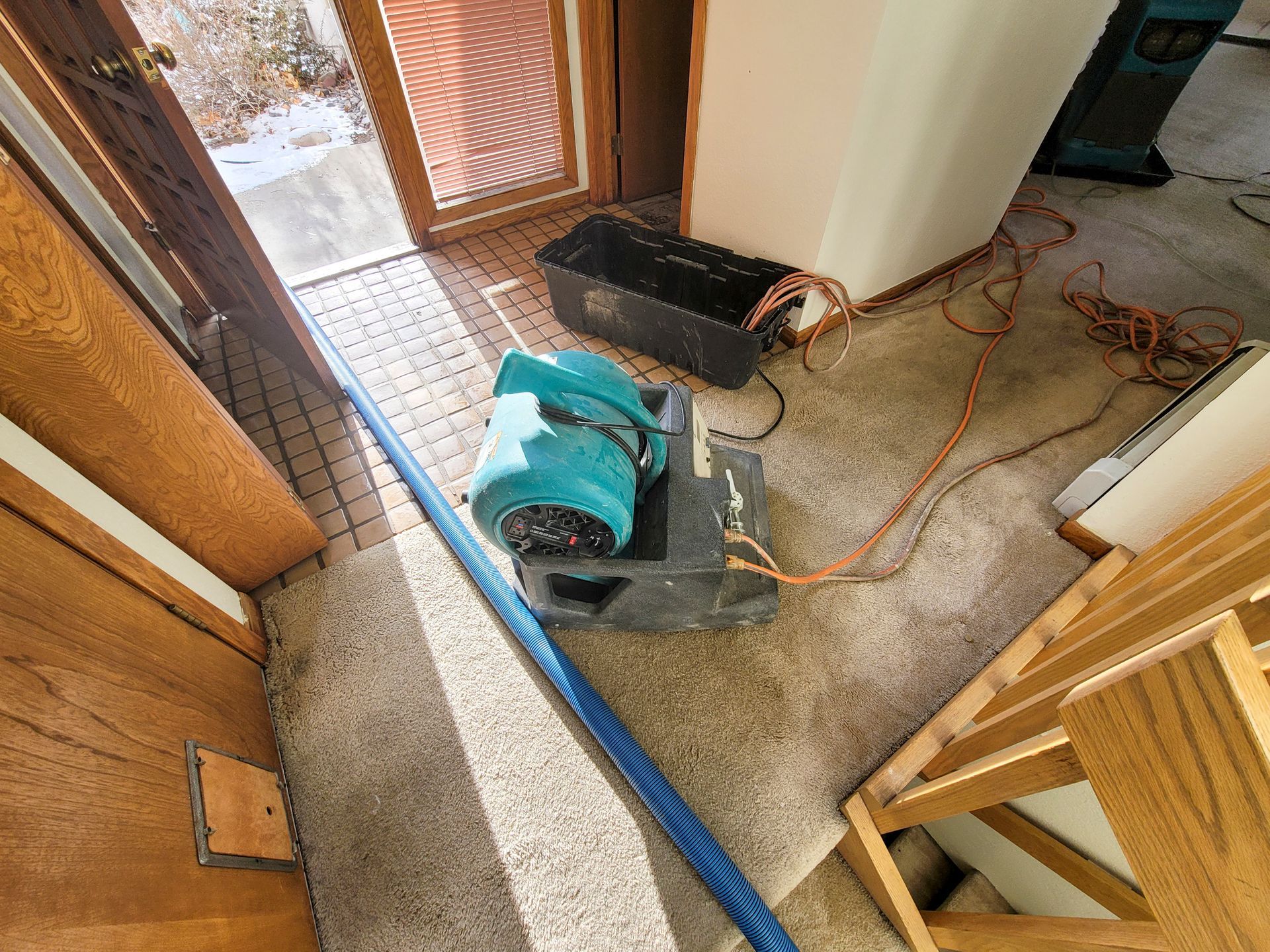 An air mover and heater placed in a water-damaged home to dry it out.