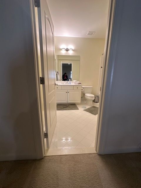 A bathroom with a sink , toilet and mirror.