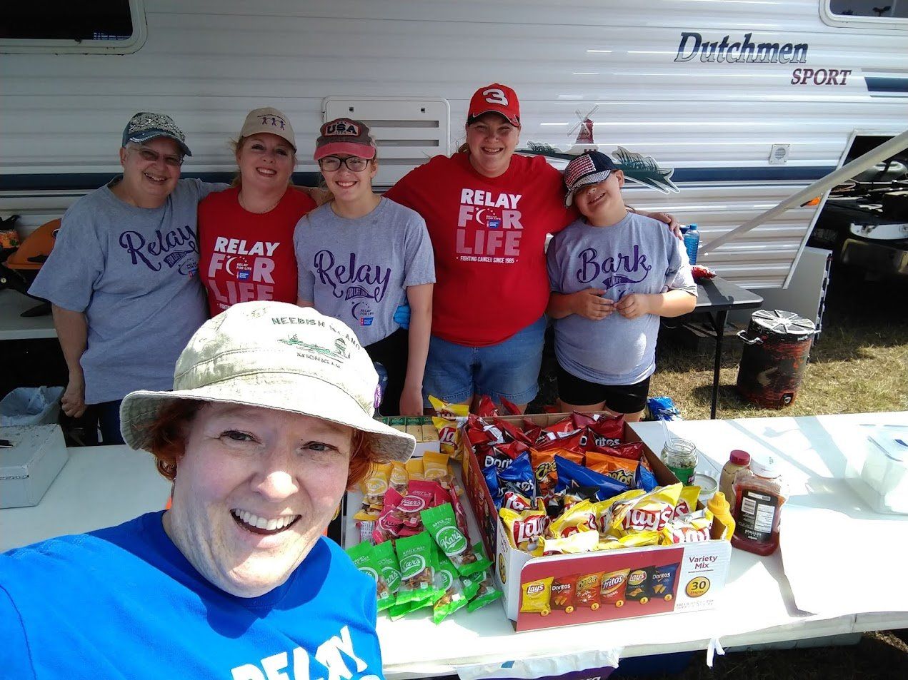 Electrolysis — Volunteer Team Taking A Picture With Snacks in Marie, MI