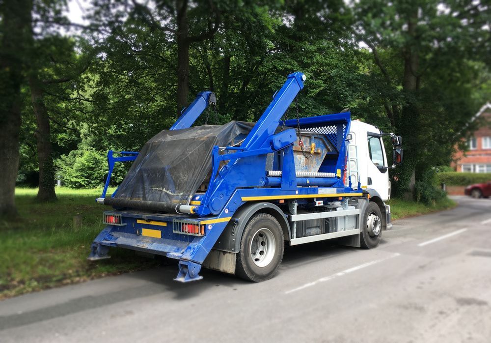 Blue and White Hook-lift Truck Parked on a Road, With a Large Container  — Mission Truck Training in Mountain Creek, QLD