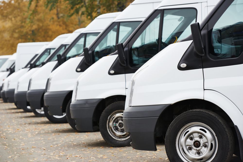 White Delivery Vans Parked in a Row on a Paved Surface — Mission Truck Training in Caloundra, QLD