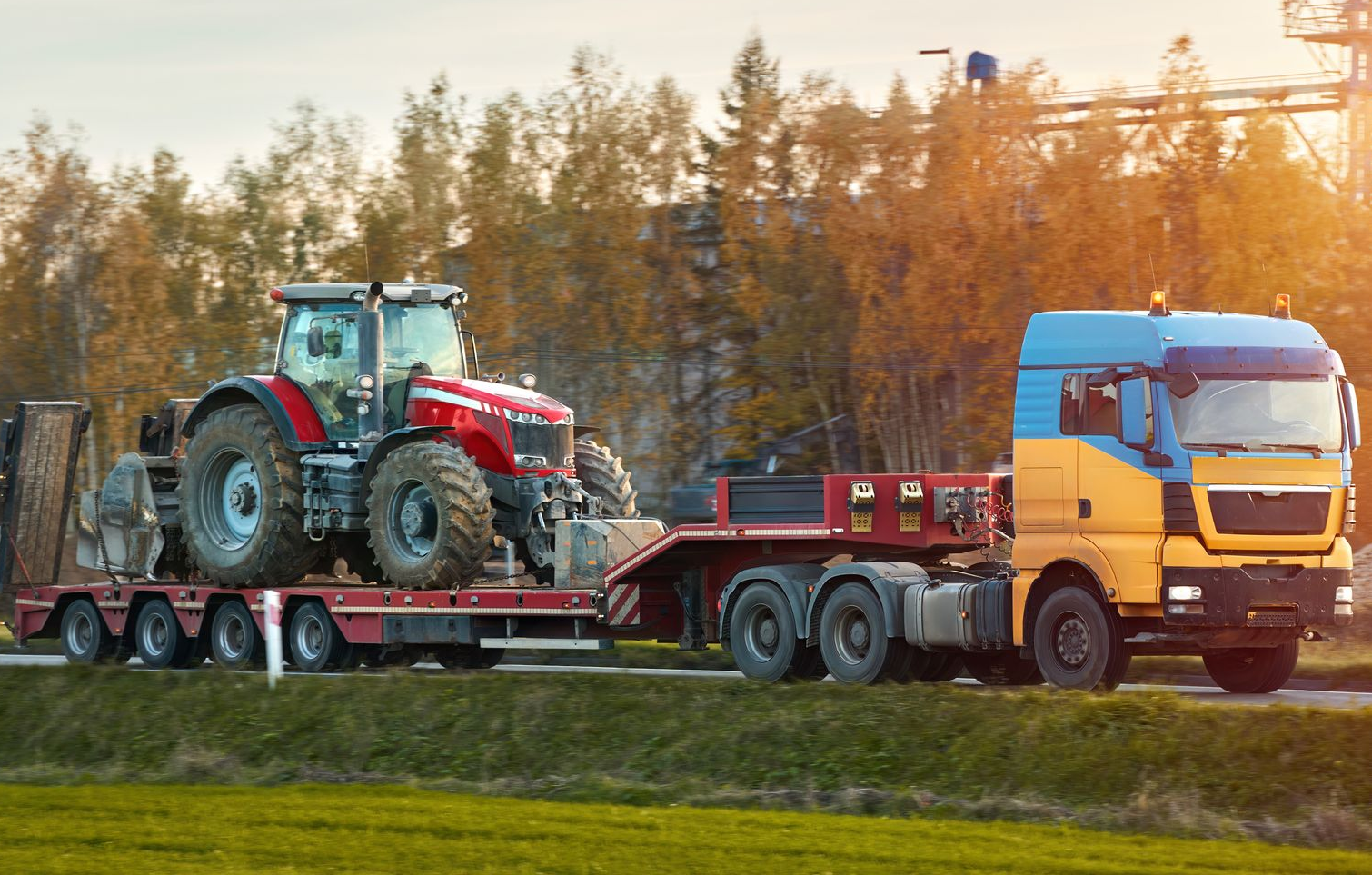 Tractor on a Flatbed Trailer Being Pulled — Mission Truck Training in Mountain Creek, QLD