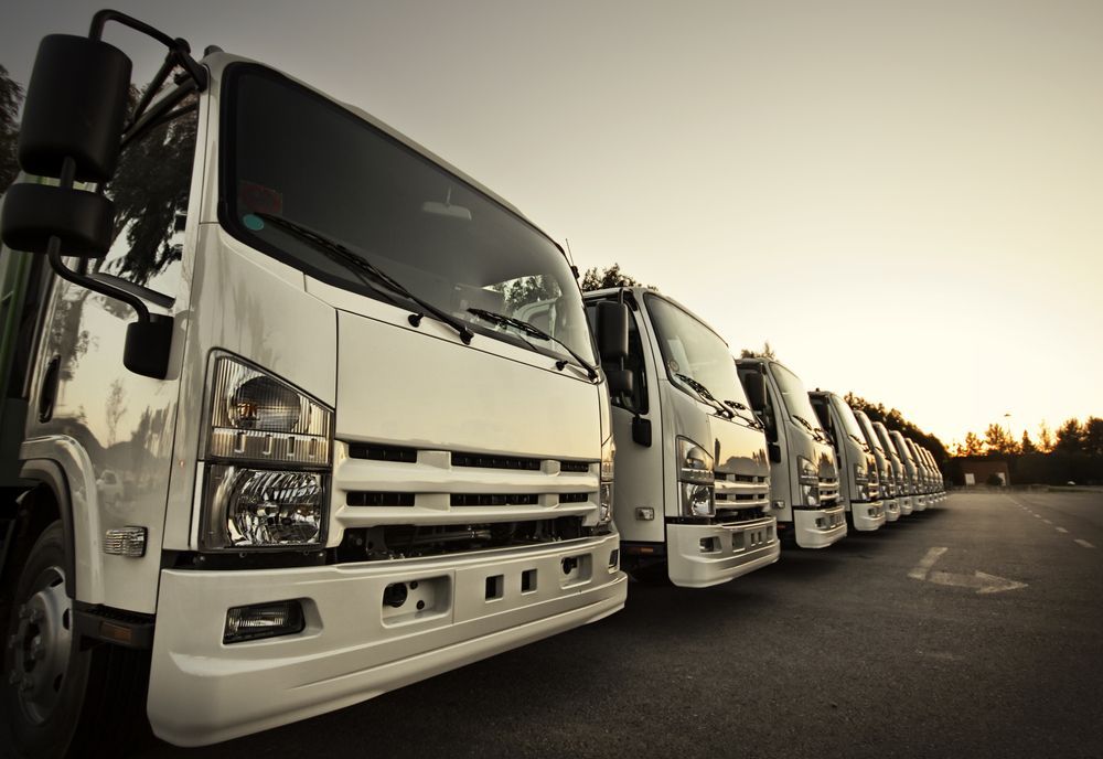 White Delivery Trucks Parked in a Row, Angled Towards the Right — Mission Truck Training in Maroochydore, QLD