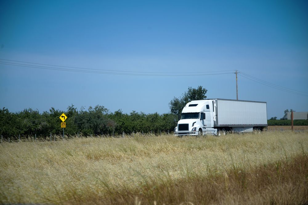 White Semi-truck on a Road Next to a Field — Mission Truck Training in Fraser Coast, QLD