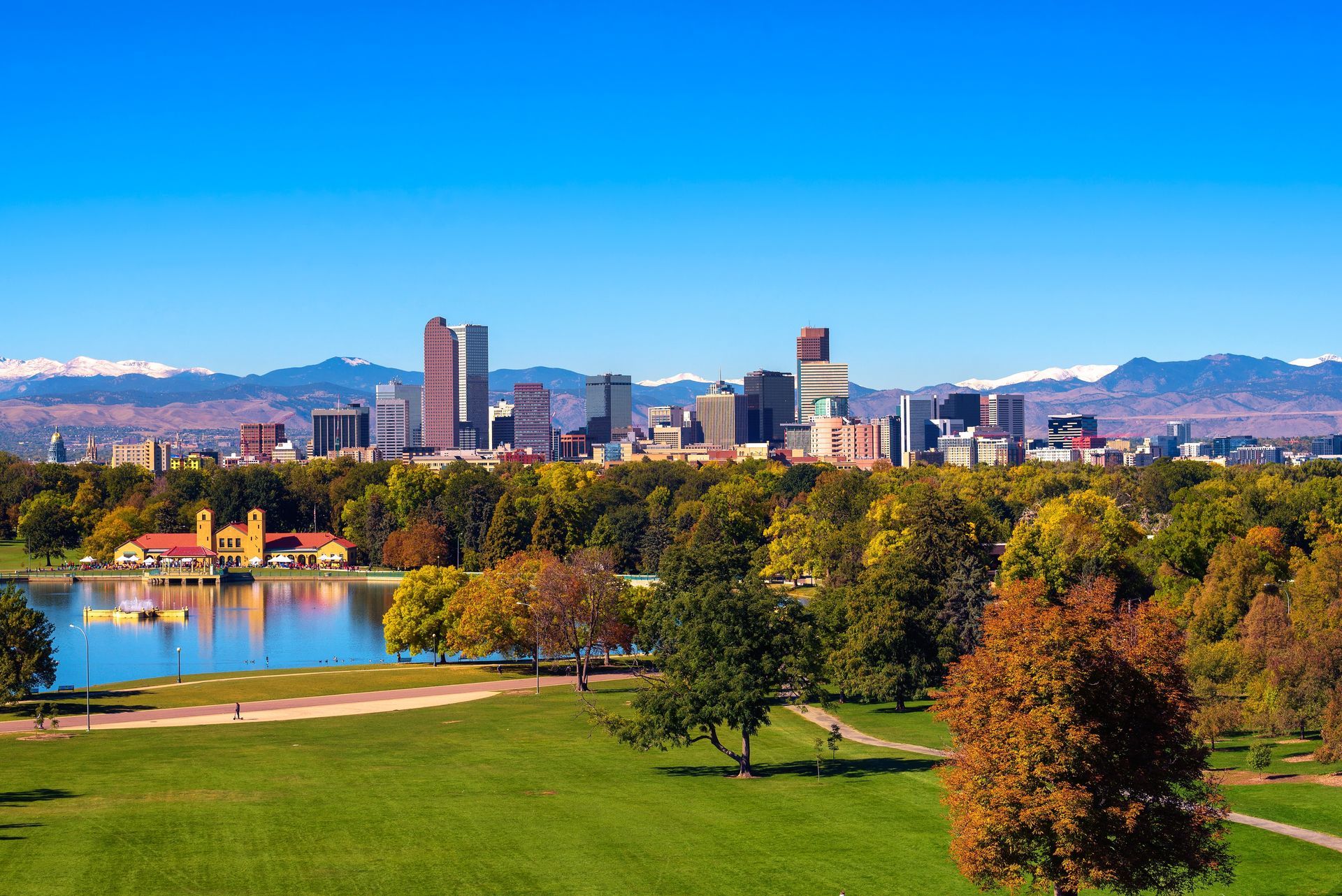 An aerial view of a park with a city skyline in the background.