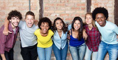 Teenage kids in a half circle with arms around one another