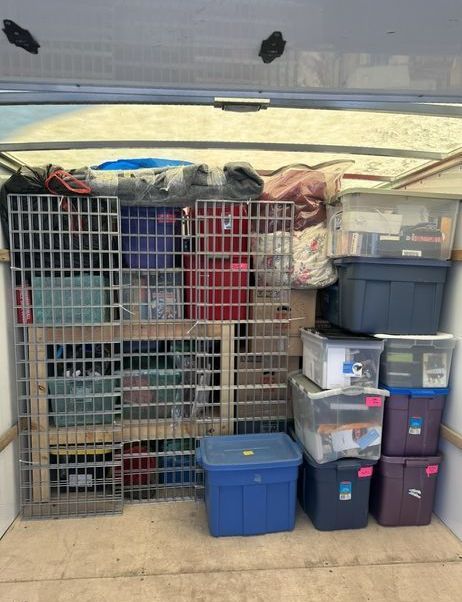 A bunch of boxes are stacked on top of each other in a garage.