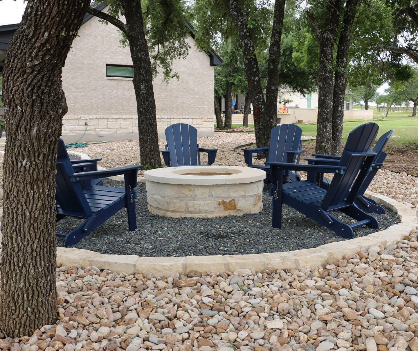Landscaping fire pit with gravel and river rock and limestone borders.  Sitting area landscaping