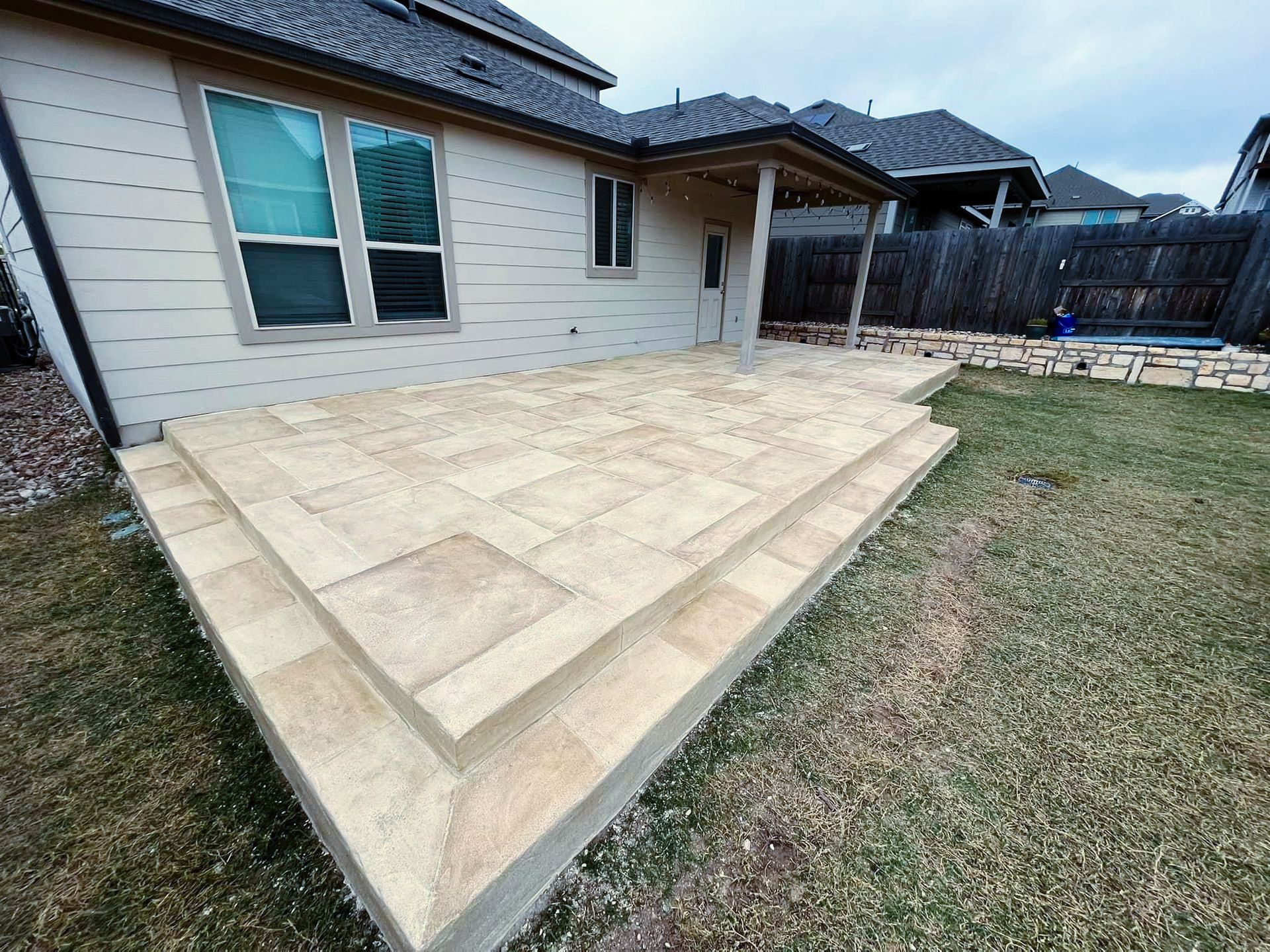 A house with a patio and stairs in front of it.