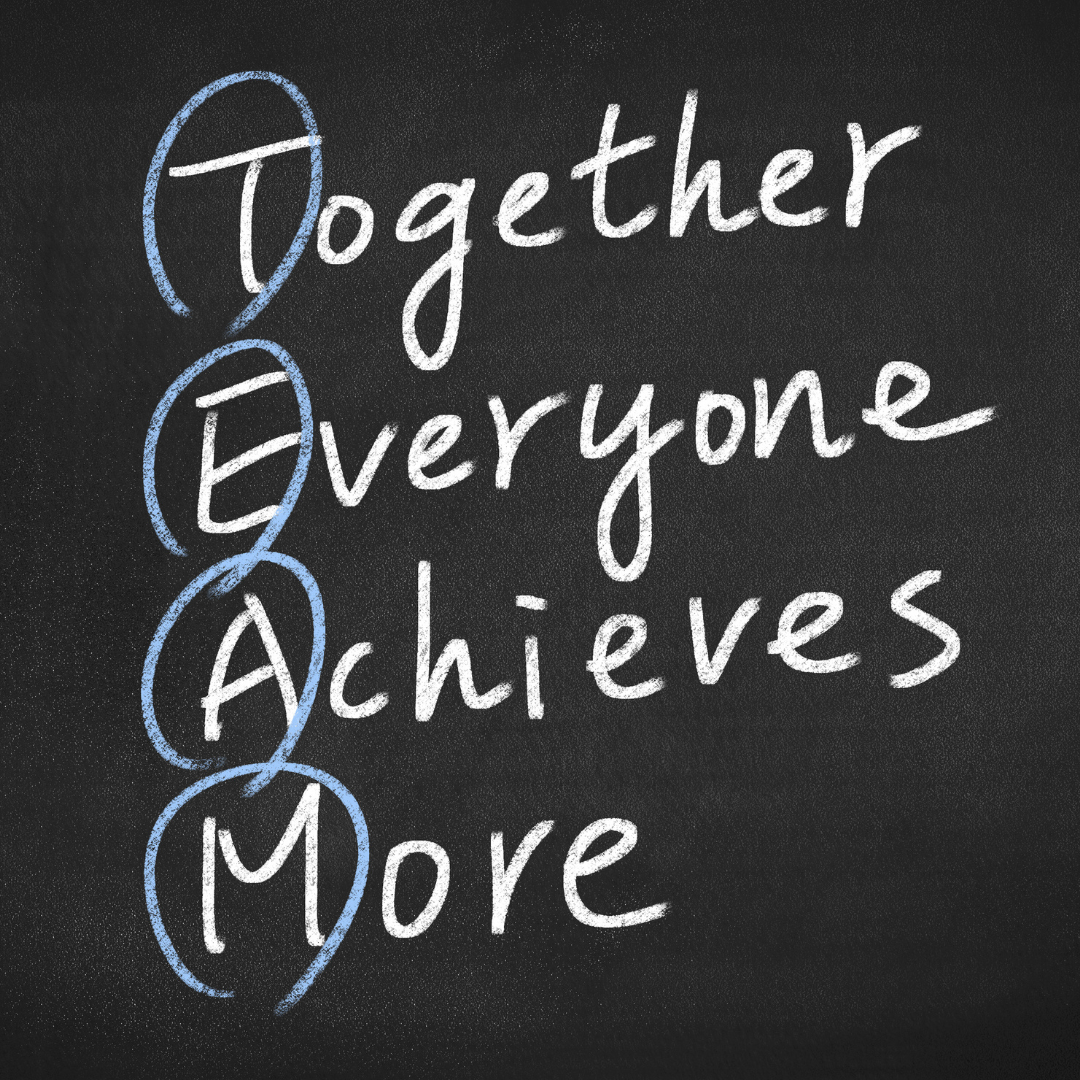 Chalkboard with the acronym 'TEAM' spelled out vertically in white chalk with each letter beginning the words 'Together Everyone Achieves More', highlighted in blue, symbolizing teamwork and collaboration.