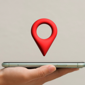 A hand holds a smartphone with a large red 3D location pin icon hovering above it against a plain background.