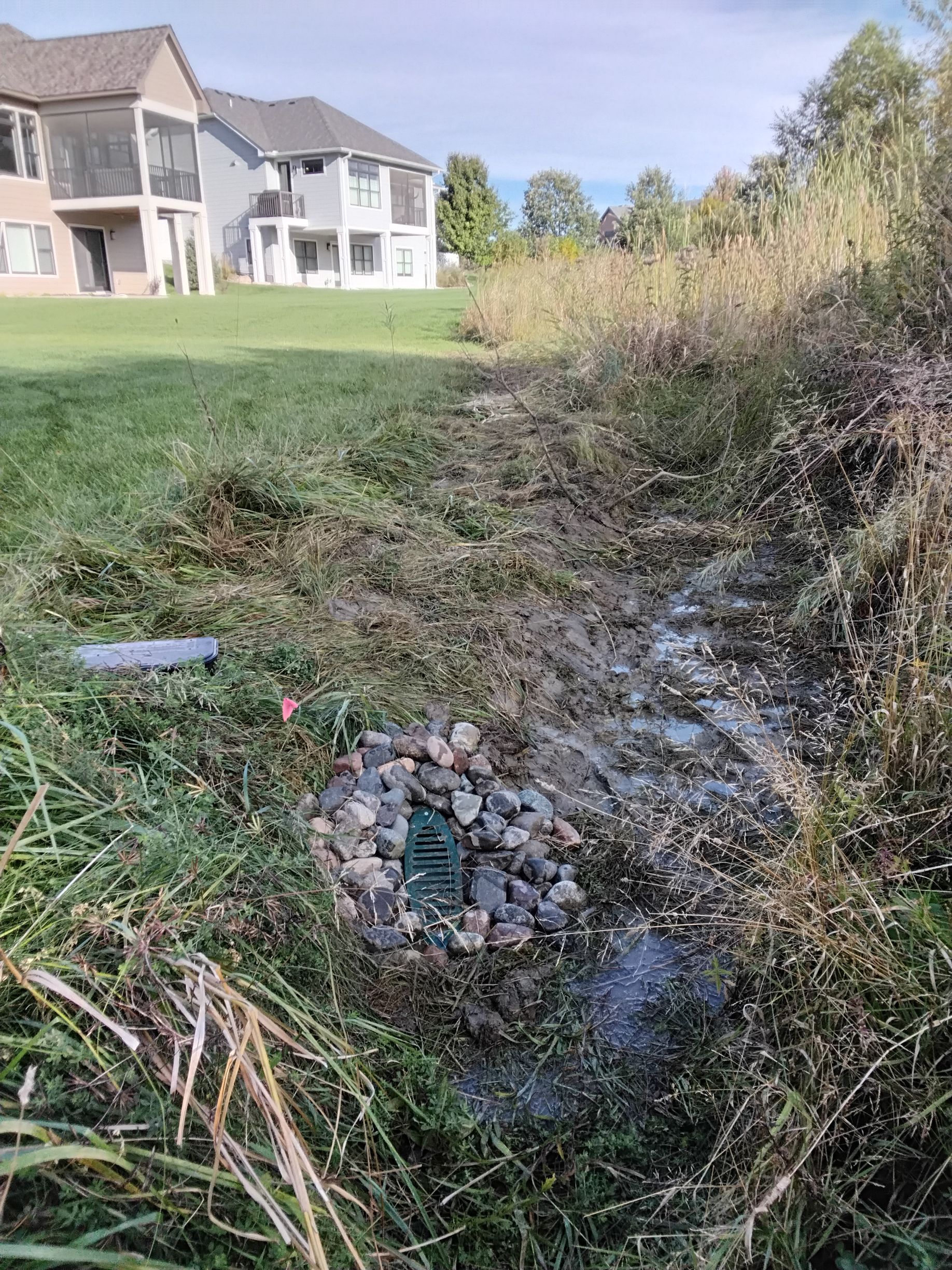 Discharge end of French drain system that drains into natural space via a 45 degree daylight emitter 