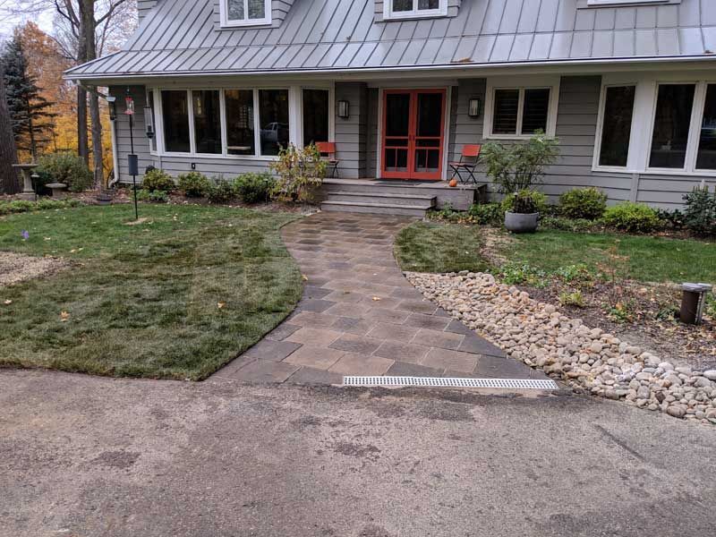 A house with a walkway leading to the front door