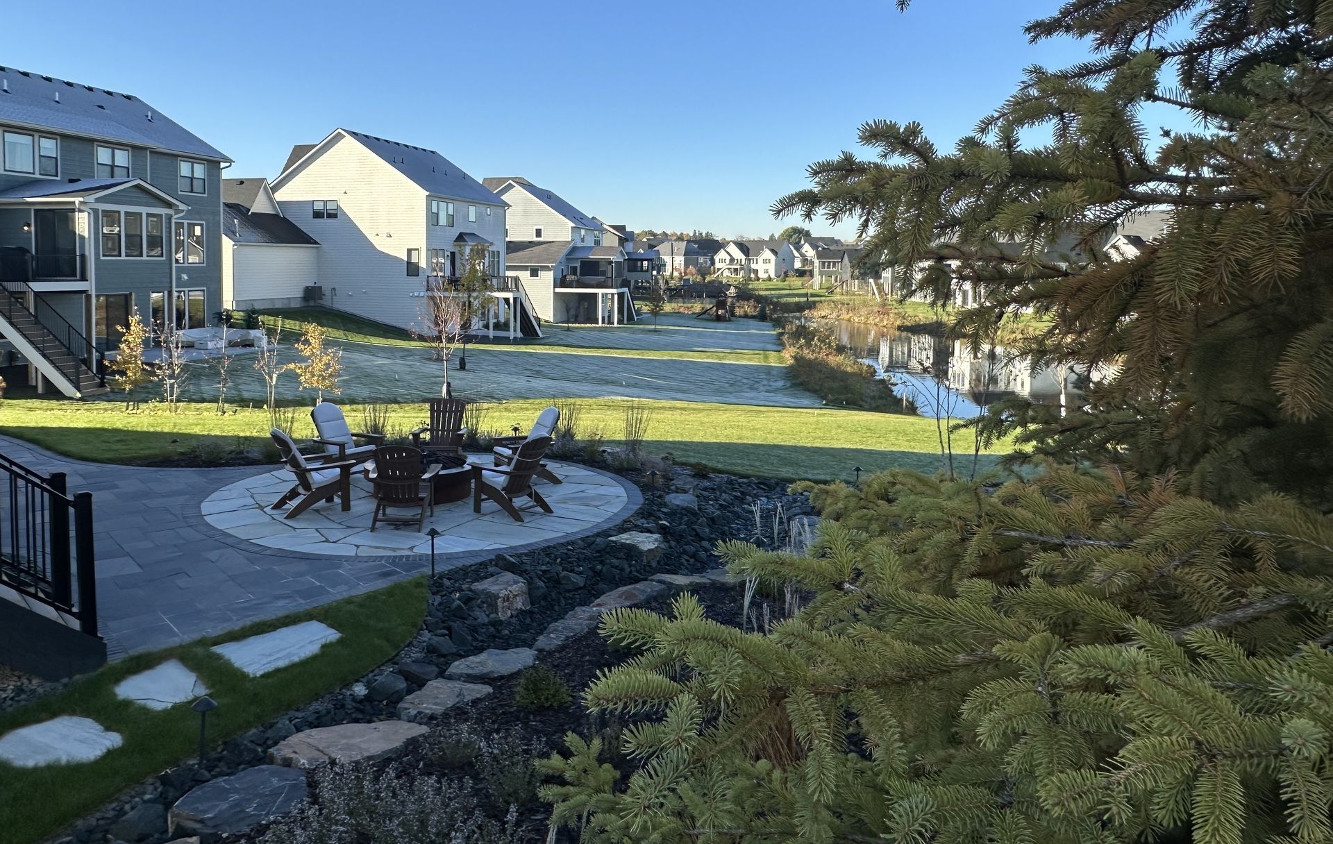 Backyard raised round flagstone fire area.