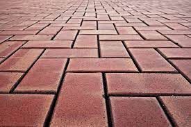 A close up of a brick walkway with a diagonal pattern.