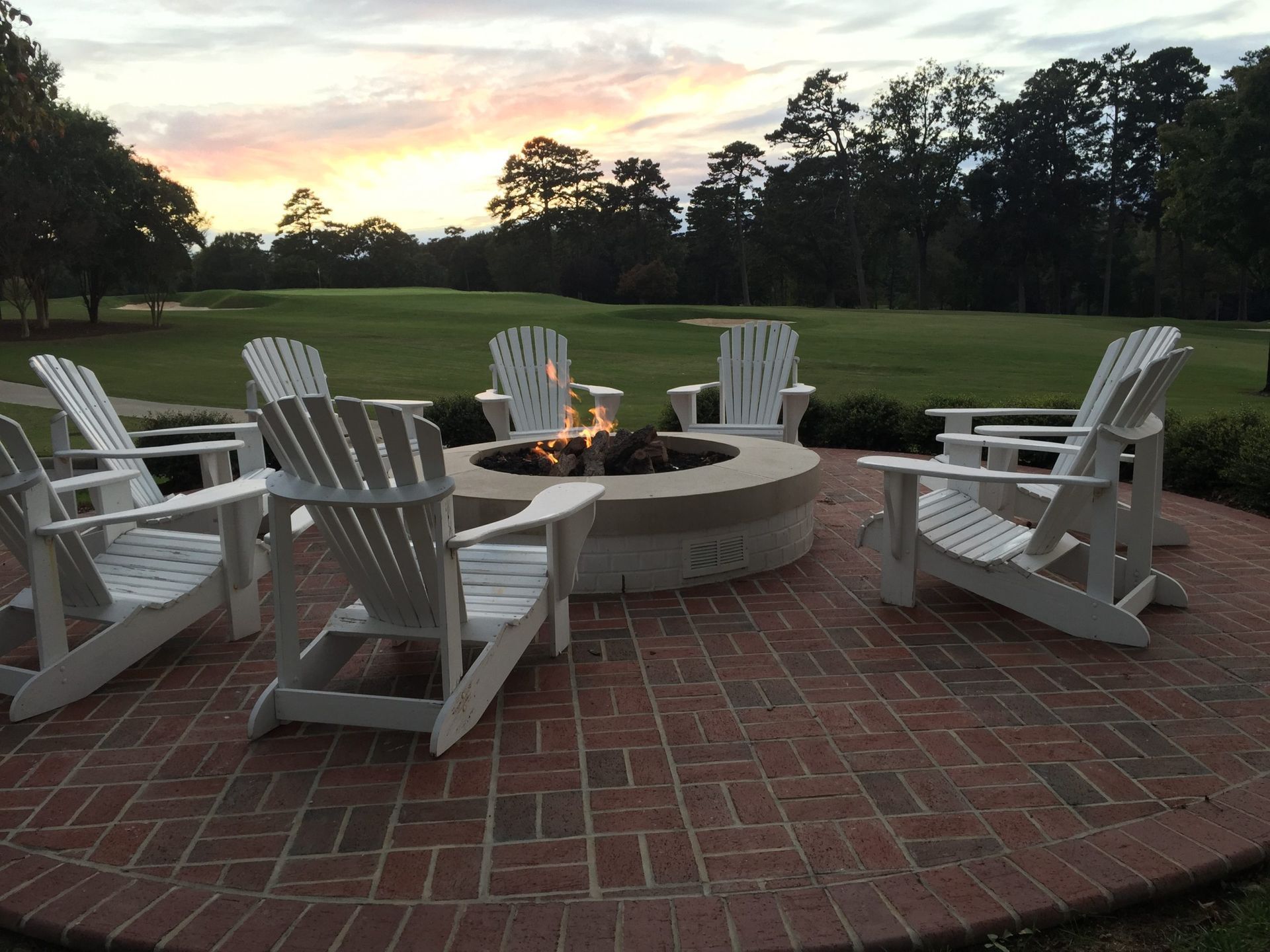 A group of chairs are sitting around a fire pit
