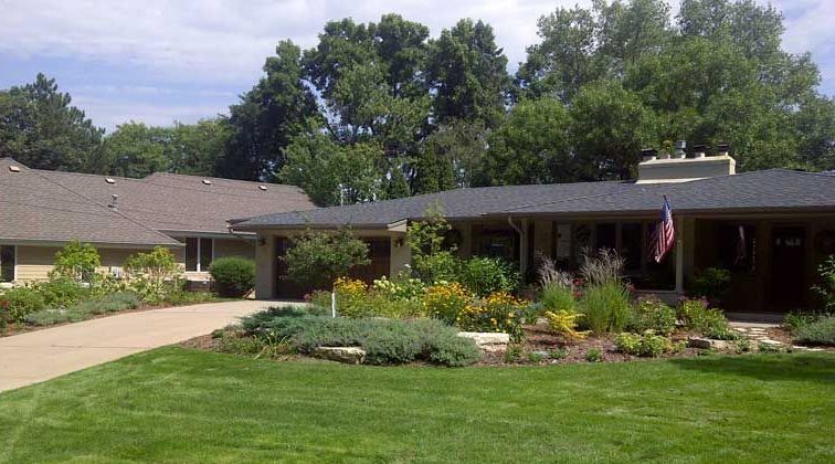 Front yard landscaping inspirational picture with large beds interesting boulder outcroppings landscaping with gray white limestone front yard in Edina Minnesota KGLandscape.com