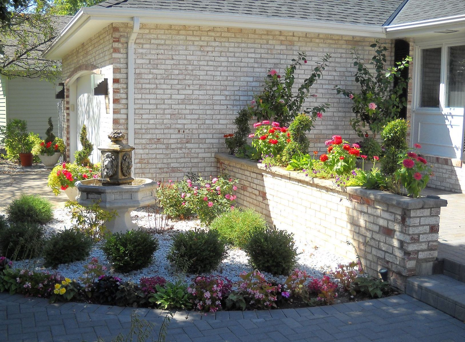 front yard landscaping boxwoods paver walkway flowers annuals fountain hibiscus golden valley MN KG Landscape designer