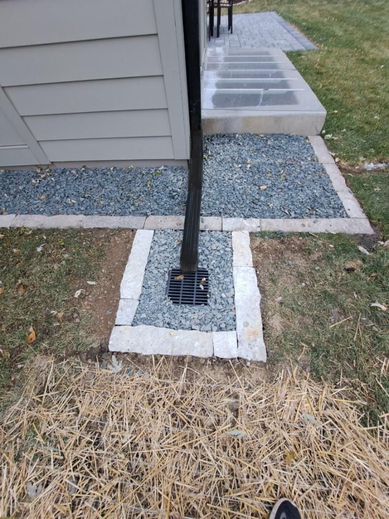 A patio with a fire pit and a sectional couch