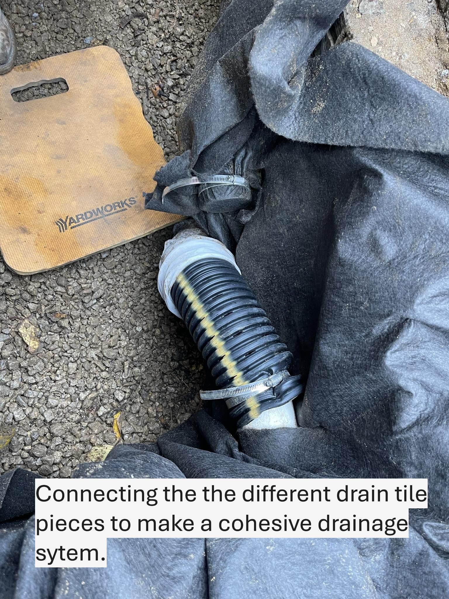 Black corrugated drain tile pieces being connected with metal clamps.
