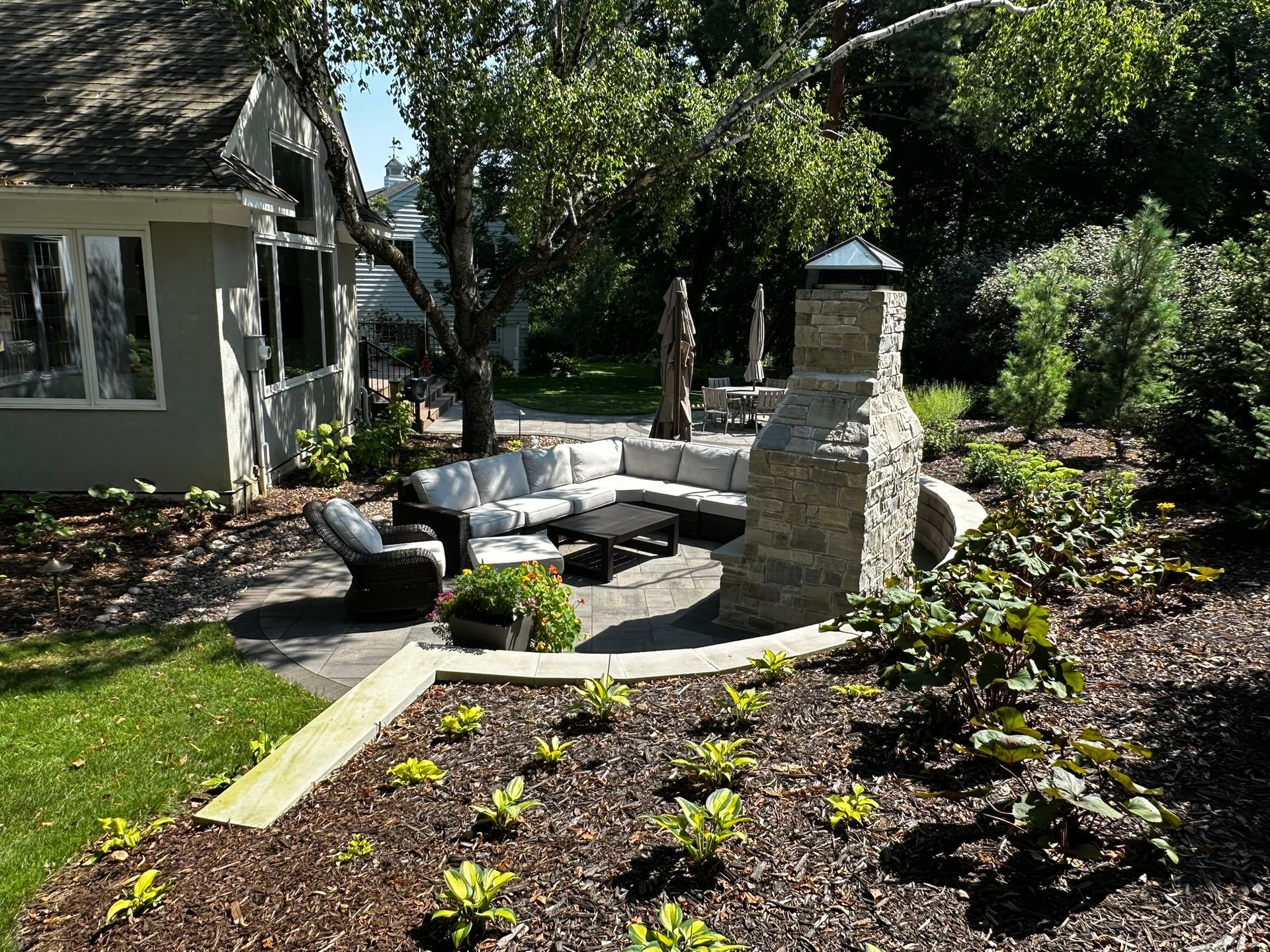 Sloped backyard with firepit.